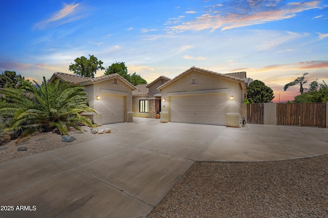 422 E Kaibab Pl, Chandler, AZ 85249 - view of front of house with a garage, driveway, stucco siding, a tiled roof, and a gate