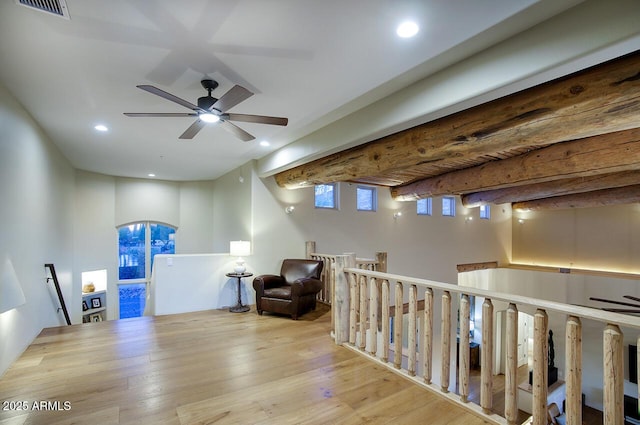 living area with visible vents, beamed ceiling, wood finished floors, an upstairs landing, and recessed lighting