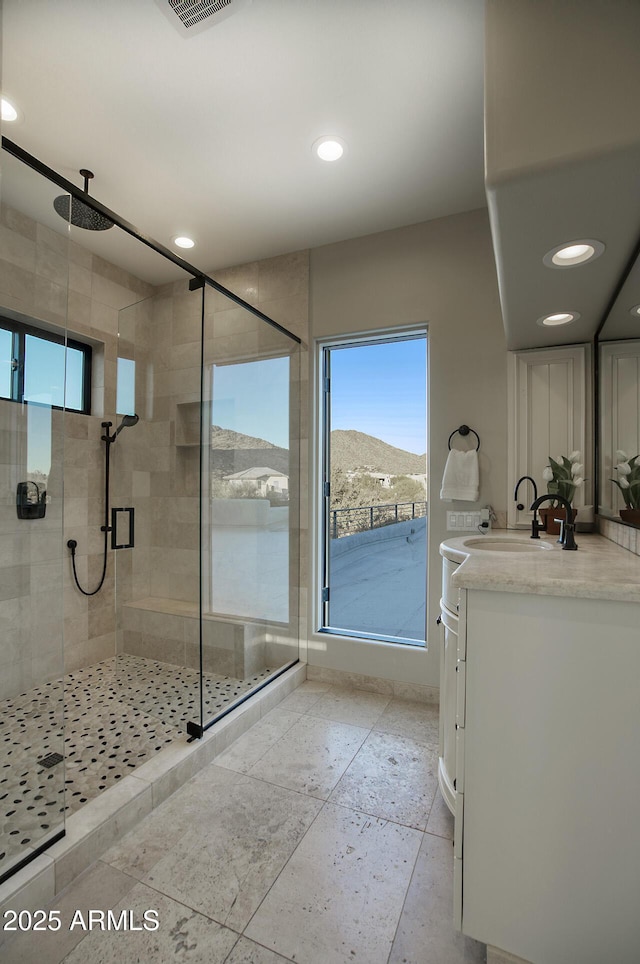 full bathroom featuring a shower stall, vanity, and recessed lighting