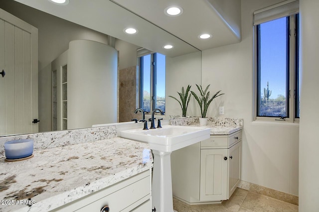 full bathroom featuring a healthy amount of sunlight, baseboards, and recessed lighting