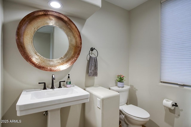 bathroom featuring toilet and a sink