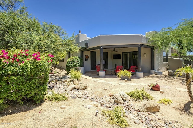 view of front of home with ceiling fan, a patio, and stucco siding