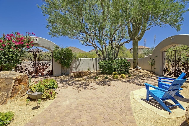 view of patio / terrace featuring a fenced backyard and a mountain view