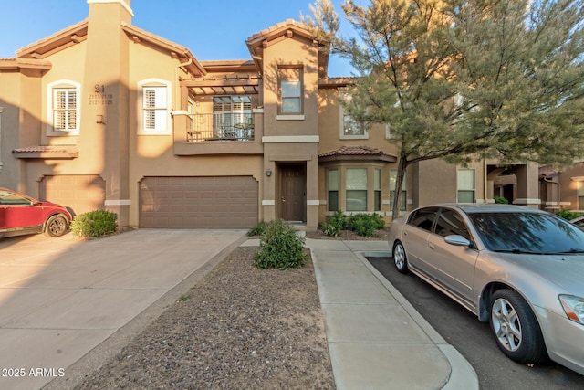 multi unit property featuring a balcony and a garage