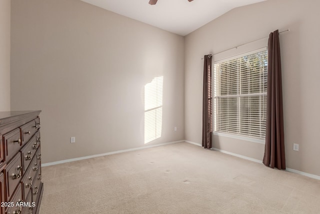 unfurnished room featuring ceiling fan, light colored carpet, and vaulted ceiling