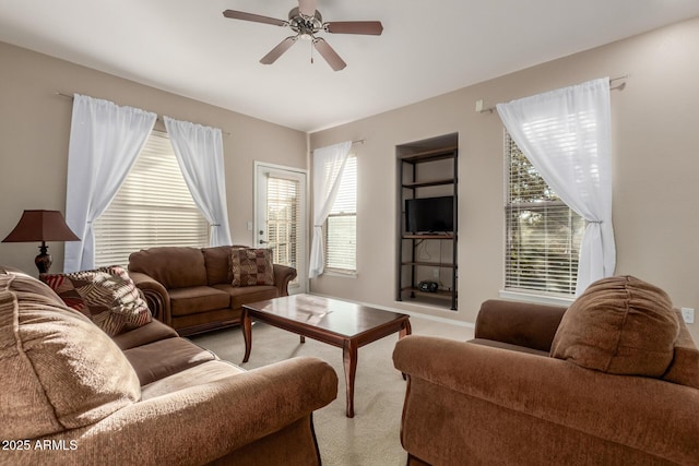 living room featuring light carpet, a wealth of natural light, and ceiling fan