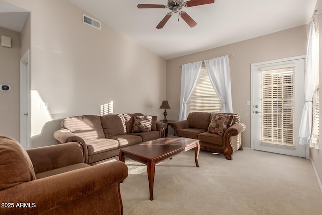 carpeted living room featuring ceiling fan