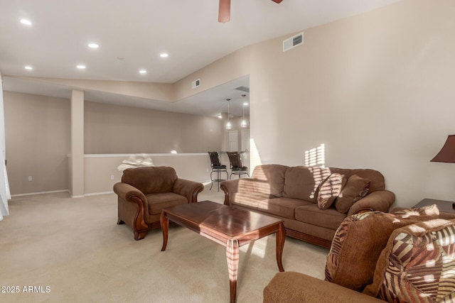 living room featuring ceiling fan and light colored carpet