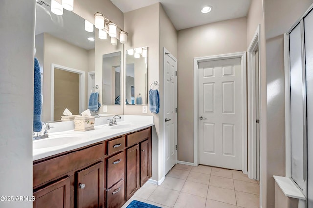 full bath with tile patterned flooring, double vanity, and a sink