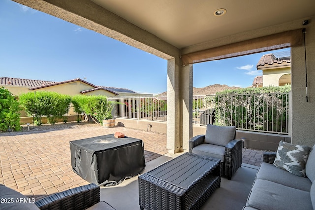 view of patio featuring outdoor lounge area, a fenced backyard, and a mountain view