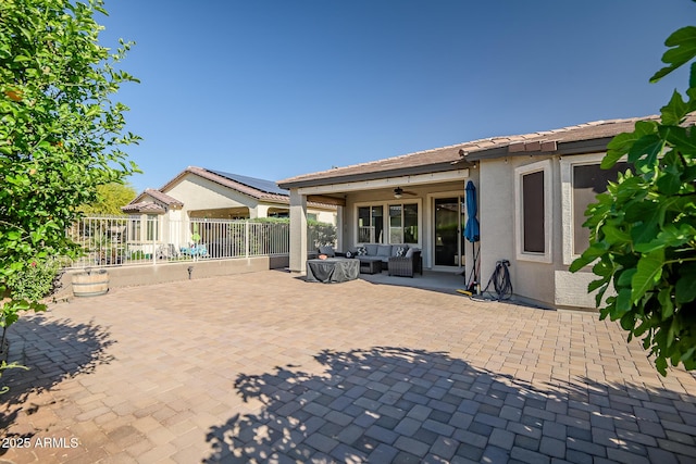 view of patio / terrace featuring an outdoor living space, fence, and a ceiling fan
