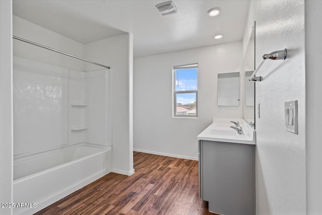618 E Elm Ln, Avondale, AZ 85323 - bathroom featuring wood finished floors, visible vents, vanity, baseboards, and washtub / shower combination