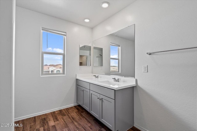 618 E Elm Ln, Avondale, AZ 85323 - bathroom with double vanity, wood finished floors, a sink, and baseboards