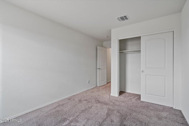 618 E Elm Ln, Avondale, AZ 85323 - unfurnished bedroom with baseboards, carpet, visible vents, and a closet