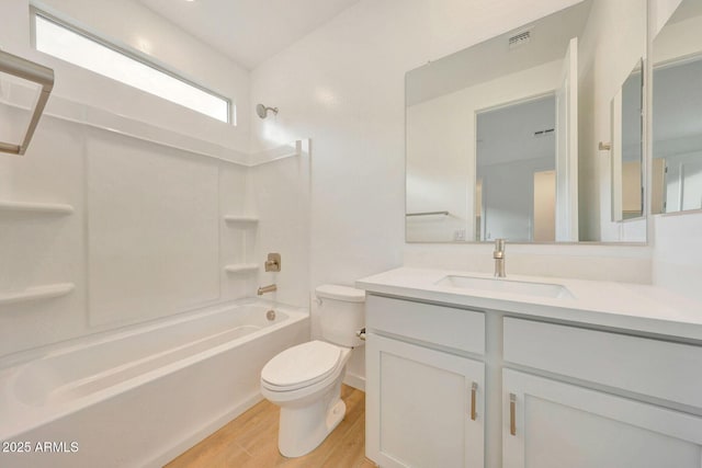 full bath with vanity, wood finished floors, visible vents, bathing tub / shower combination, and toilet