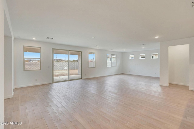 unfurnished room with recessed lighting, visible vents, light wood-type flooring, and baseboards