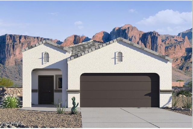 view of front of property featuring a mountain view, stucco siding, driveway, and a garage