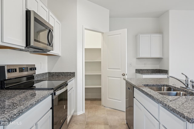 kitchen featuring white cabinets, stainless steel appliances, and a sink