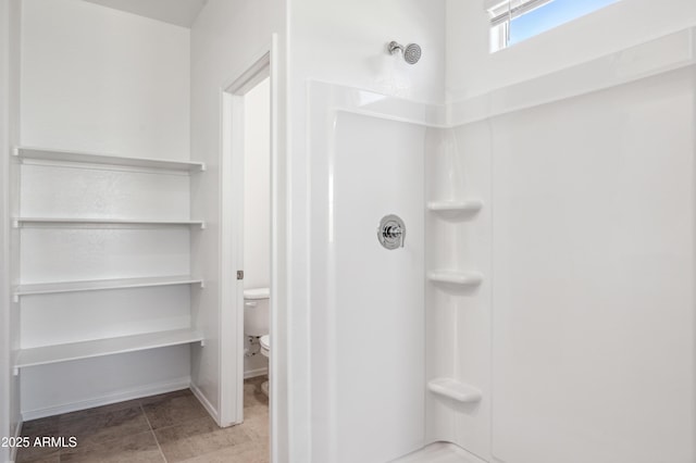 full bath with a shower, toilet, and tile patterned flooring