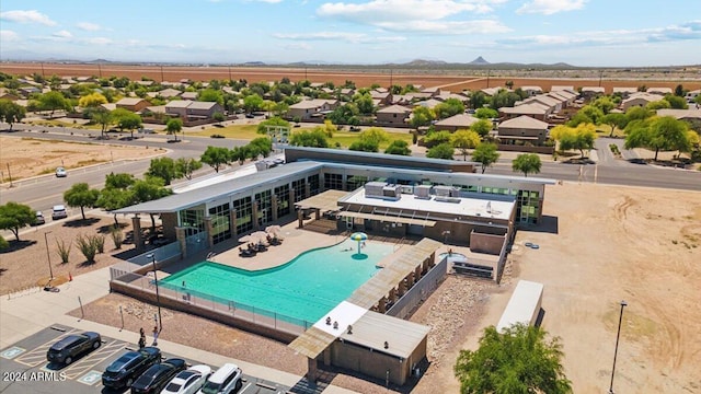 pool featuring a patio area, a residential view, and fence