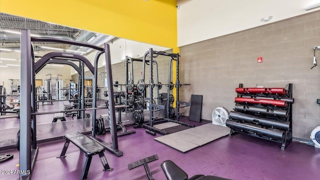 exercise room featuring concrete block wall