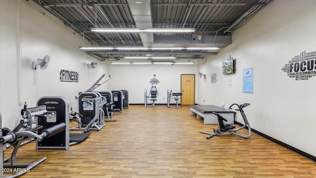 gym featuring wood finished floors and baseboards