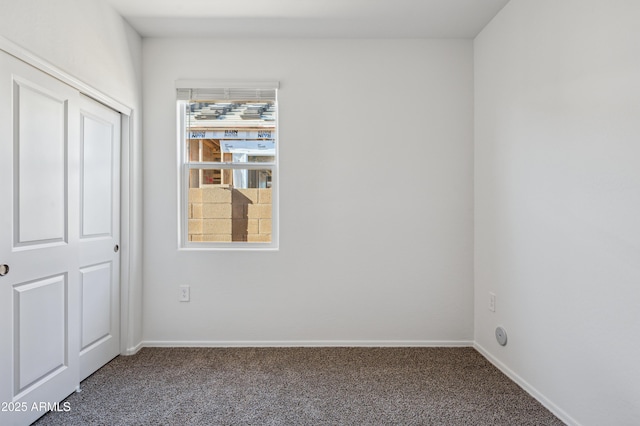 unfurnished bedroom featuring baseboards and carpet floors