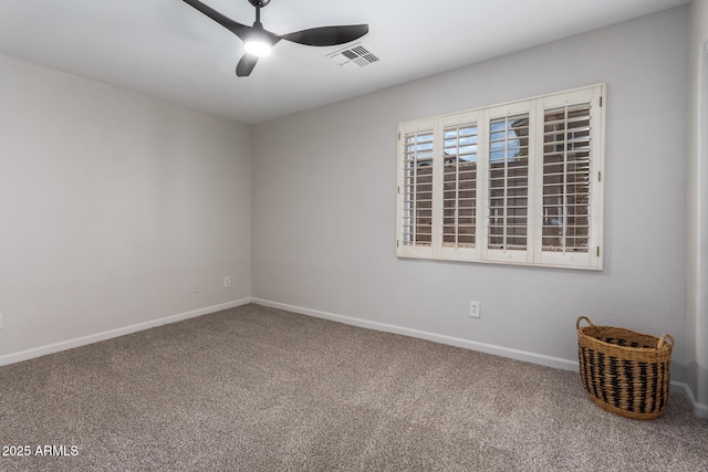 spare room with carpet, ceiling fan, visible vents, and baseboards