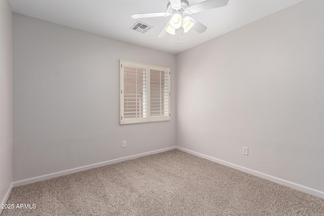 spare room featuring a ceiling fan, visible vents, carpet, and baseboards