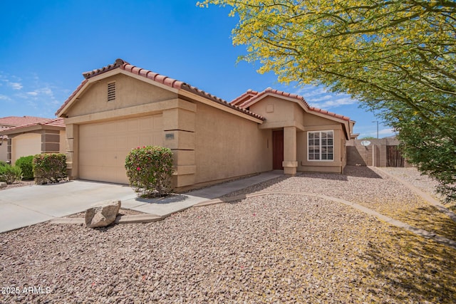view of front facade featuring an attached garage, stucco siding, a tiled roof, and fence
