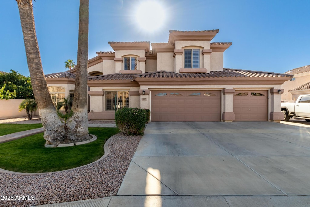 mediterranean / spanish house with a garage