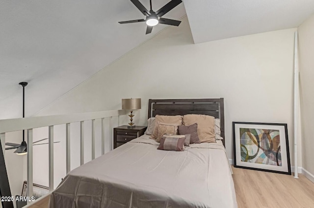 bedroom with light wood-type flooring, ceiling fan, and lofted ceiling