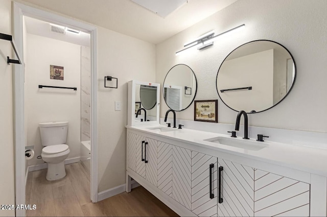 full bathroom featuring toilet, hardwood / wood-style floors, vanity, and shower / bathing tub combination