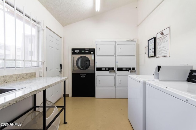 laundry room featuring stacked washer and clothes dryer, separate washer and dryer, and a textured ceiling