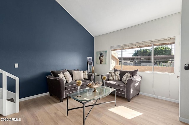 living room featuring light hardwood / wood-style floors and lofted ceiling