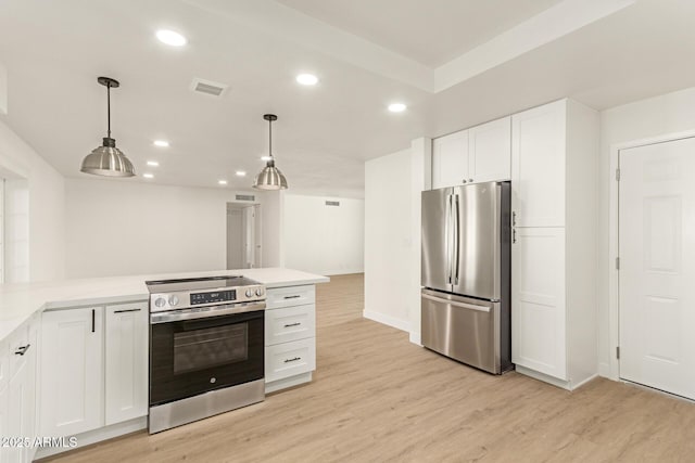 kitchen featuring white cabinetry, hanging light fixtures, stainless steel appliances, and light wood-type flooring