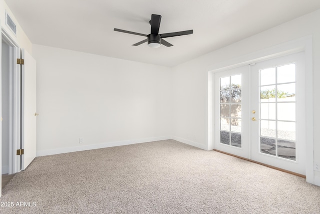 carpeted empty room with ceiling fan and french doors