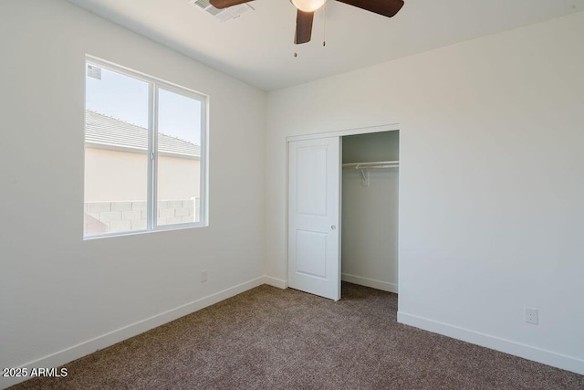 unfurnished bedroom featuring ceiling fan, a closet, and carpet