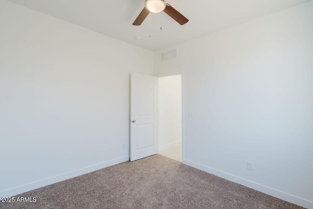 empty room featuring carpet floors and ceiling fan