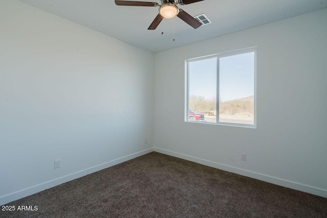 empty room featuring dark colored carpet and ceiling fan