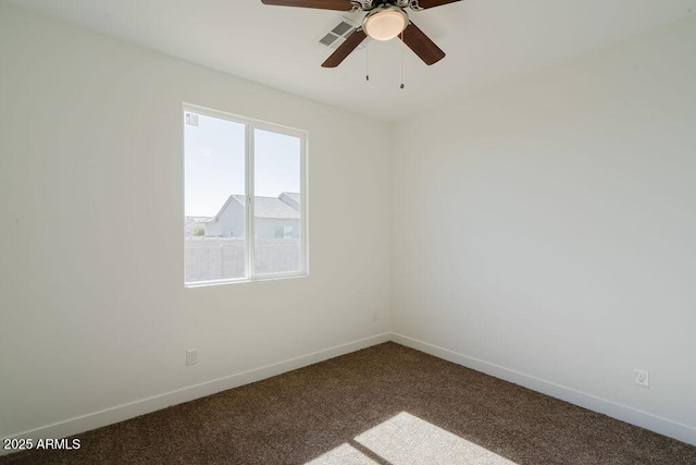 empty room featuring ceiling fan and carpet