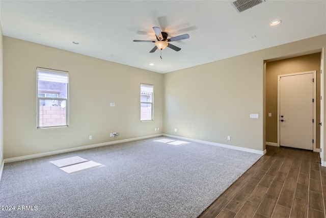 carpeted spare room with ceiling fan