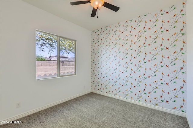 carpeted empty room featuring ceiling fan