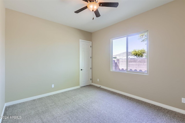 carpeted empty room with ceiling fan