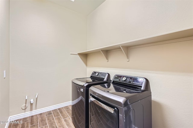 laundry room featuring wood-type flooring and washing machine and clothes dryer