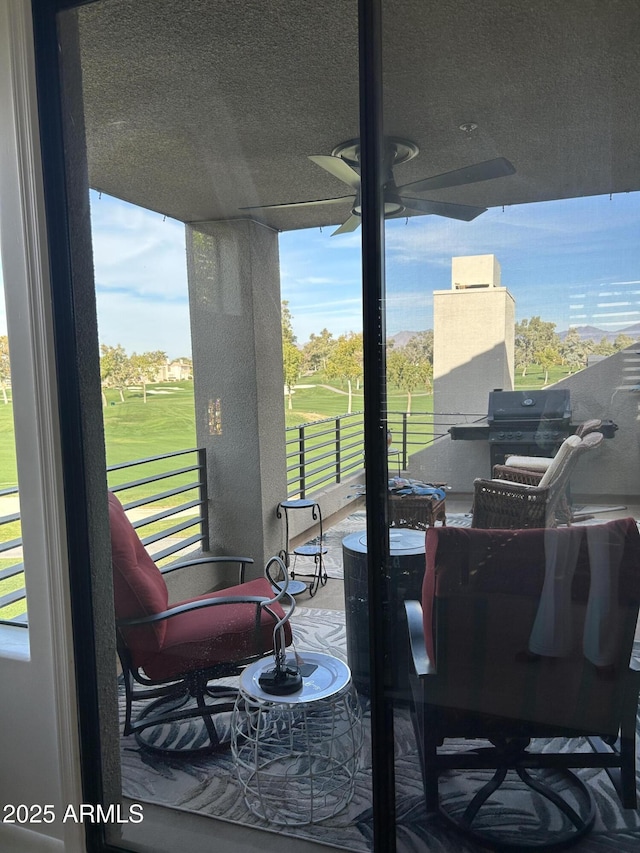 view of patio with ceiling fan and a balcony