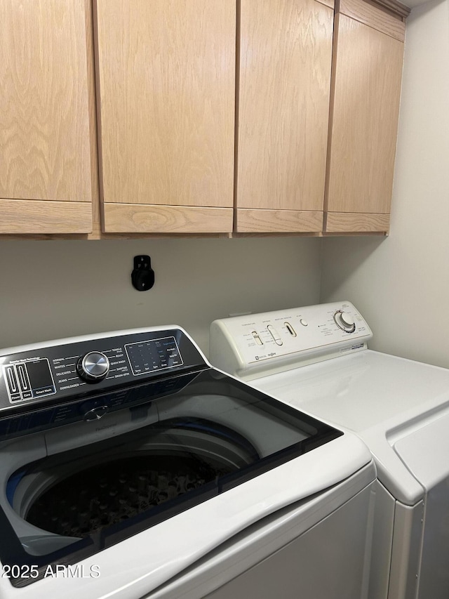 laundry area featuring cabinets and washing machine and dryer