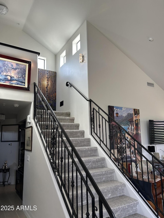 stairs with high vaulted ceiling