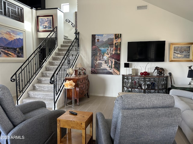 living room with wood-type flooring and high vaulted ceiling