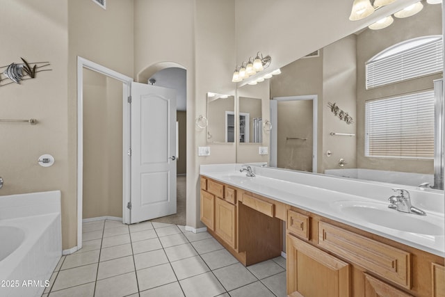 12214 W Madison St, Avondale, AZ 85323 - full bath with a garden tub, double vanity, tile patterned flooring, a towering ceiling, and baseboards